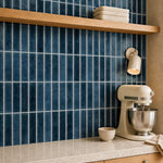 MORCART MT1386-XPE deep blue with white seams vertical linear wall tiles, oblique kitchen detail with an oak shelf and cream mixer, fine mottled print and a shallow glossy finish.