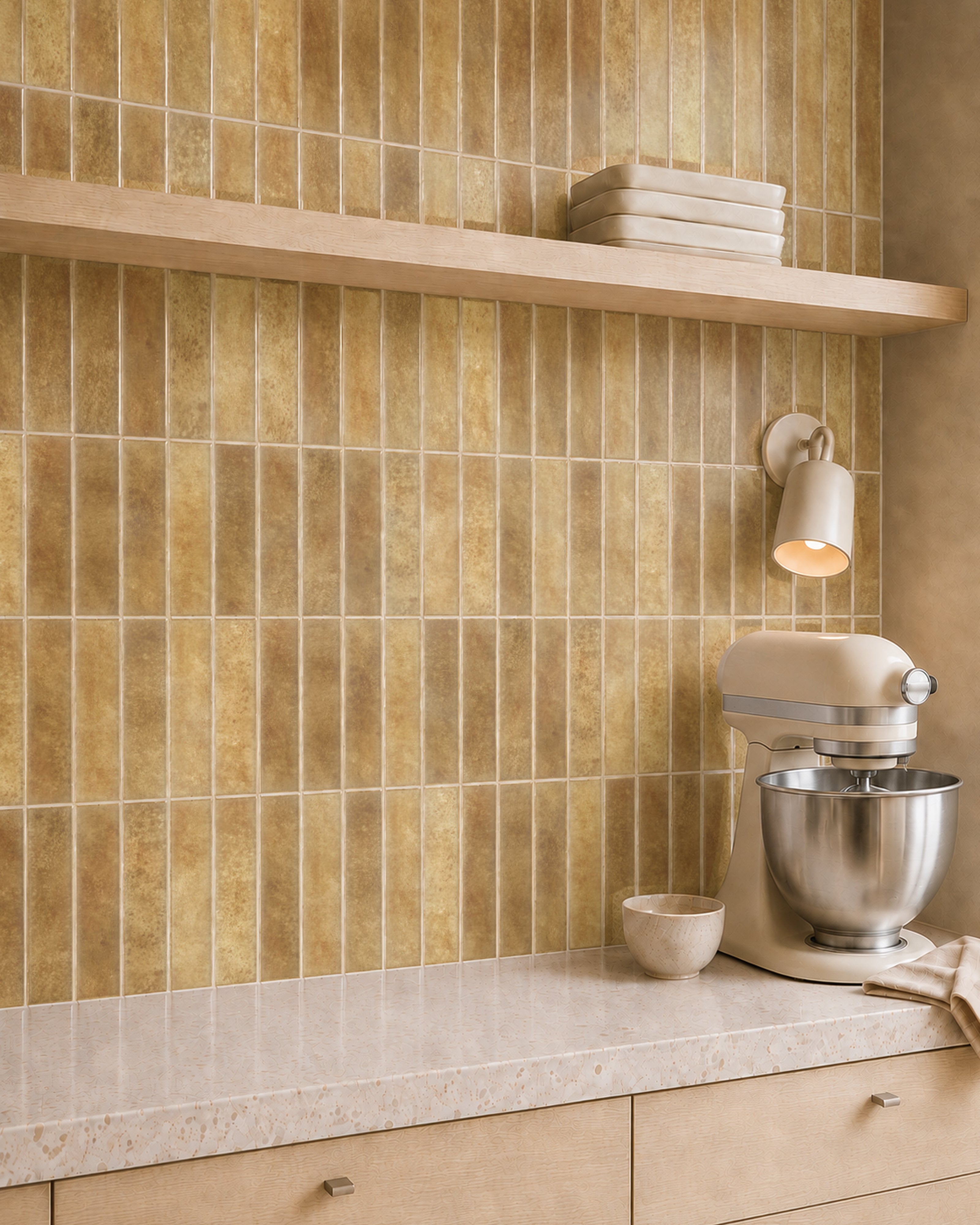 MORCART MT2208-XPE golden ochre vertical linear wall tiles, oblique kitchen detail with an oak shelf and cream mixer, fine mottled print and a shallow glossy finish.