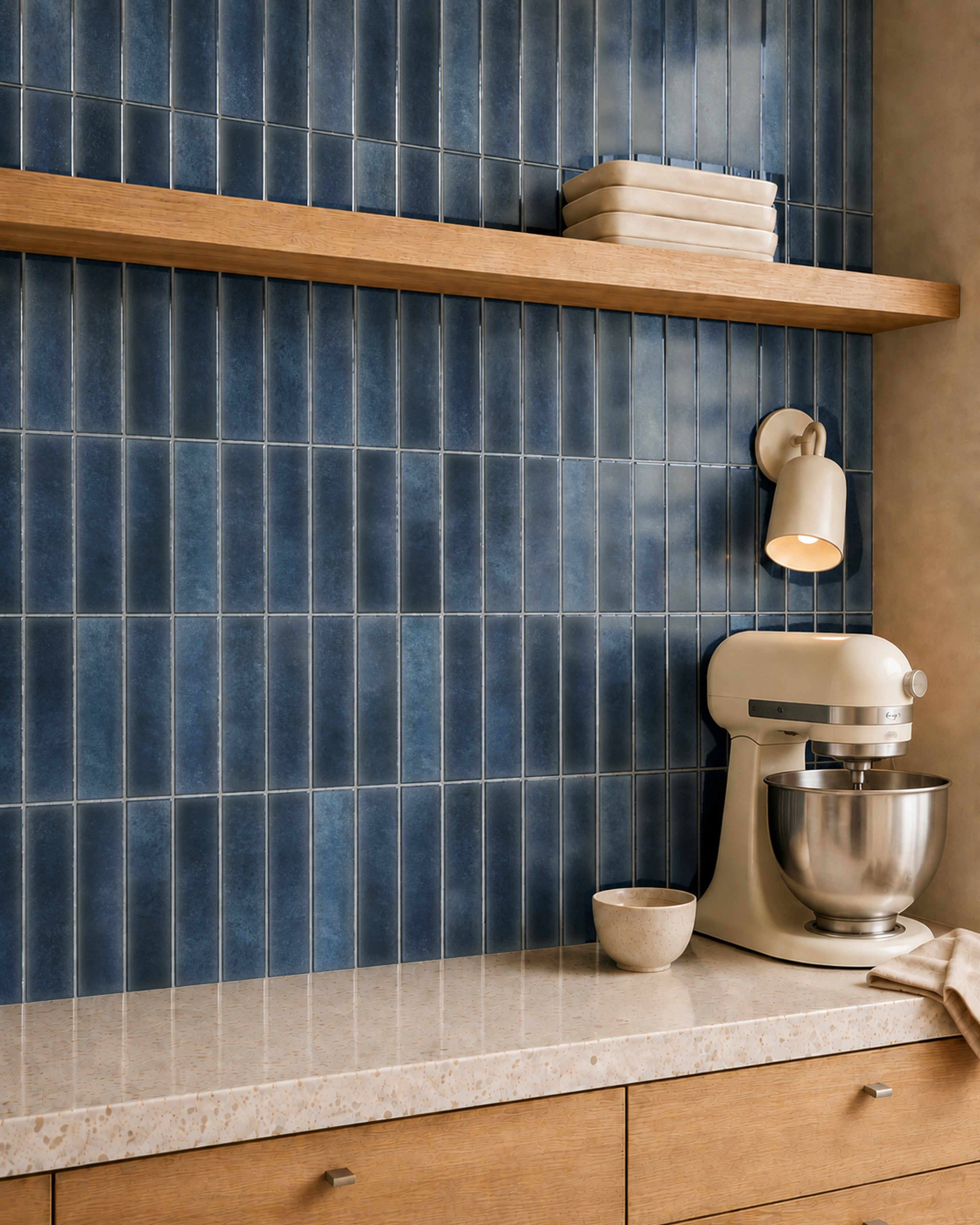 MORCART MT2212-XPE slate blue vertical linear wall tiles, oblique kitchen detail with an oak shelf and cream mixer, fine mottled print and a shallow glossy finish.